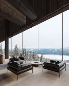 Open-concept living room with floor-to-ceiling mountain views at Aquila Landing, Revelstoke